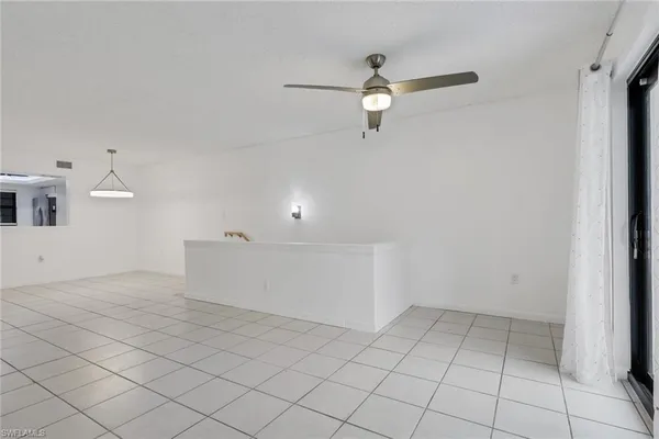 a view of a room with window and a ceiling fan