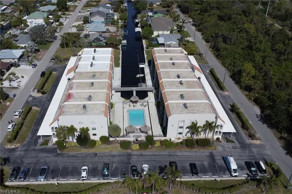 an aerial view of multi story residential apartment building with entryway