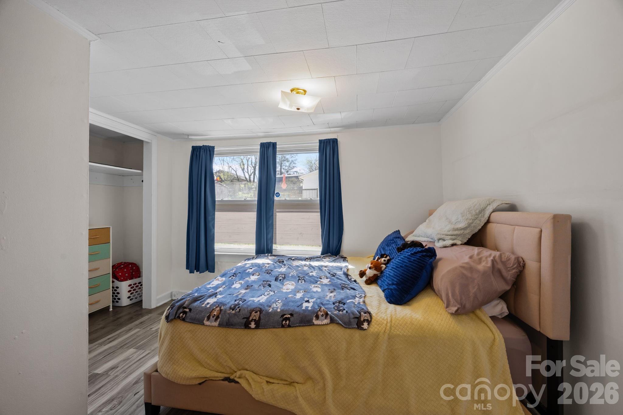 264 Church Street Marion, NC 28752 - Photo 11 of 20 a bedroom with a large bed and a large window