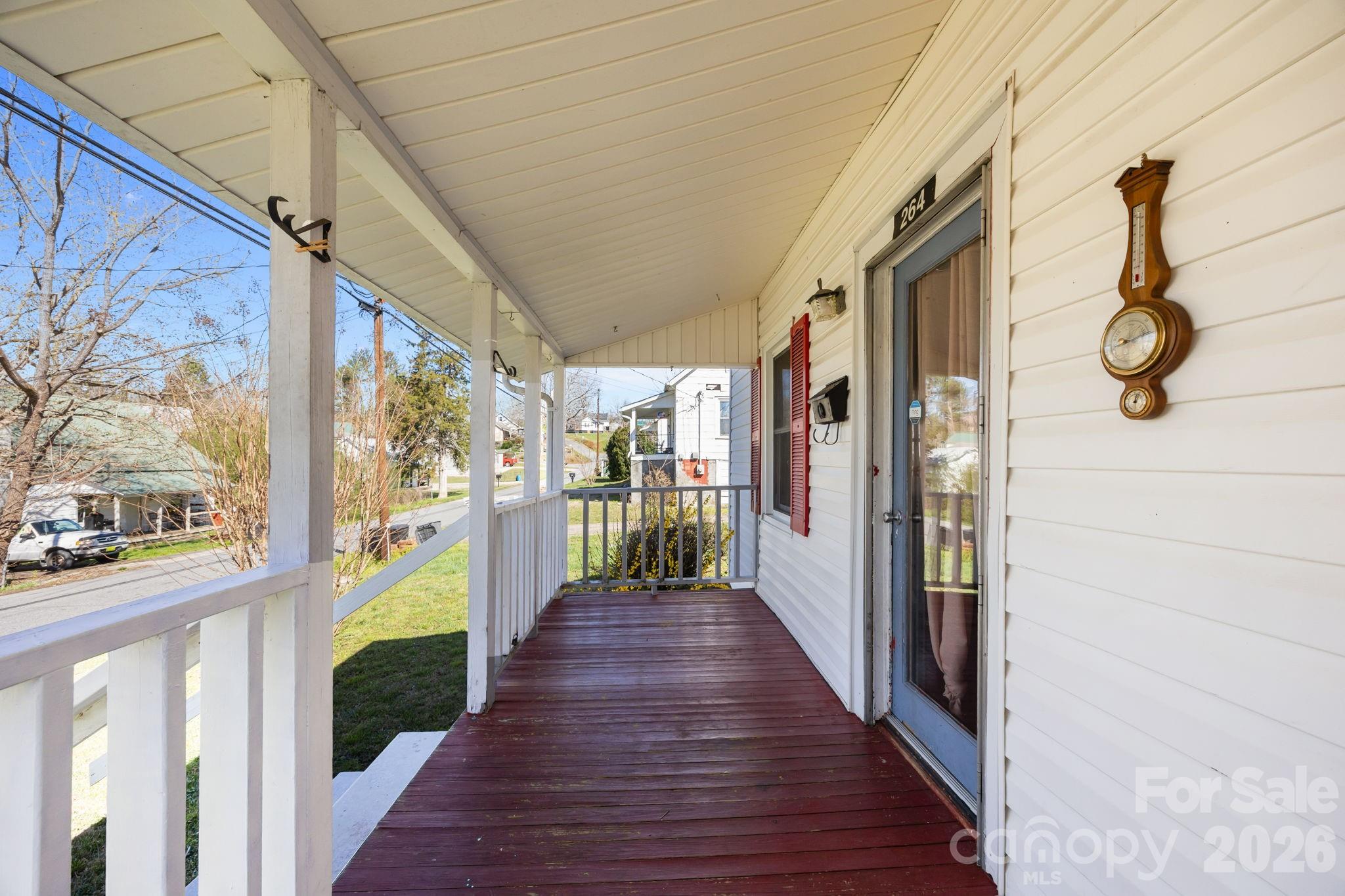 264 Church Street Marion, NC 28752 - Photo 16 of 20 a view of a porch with wooden floor and furniture