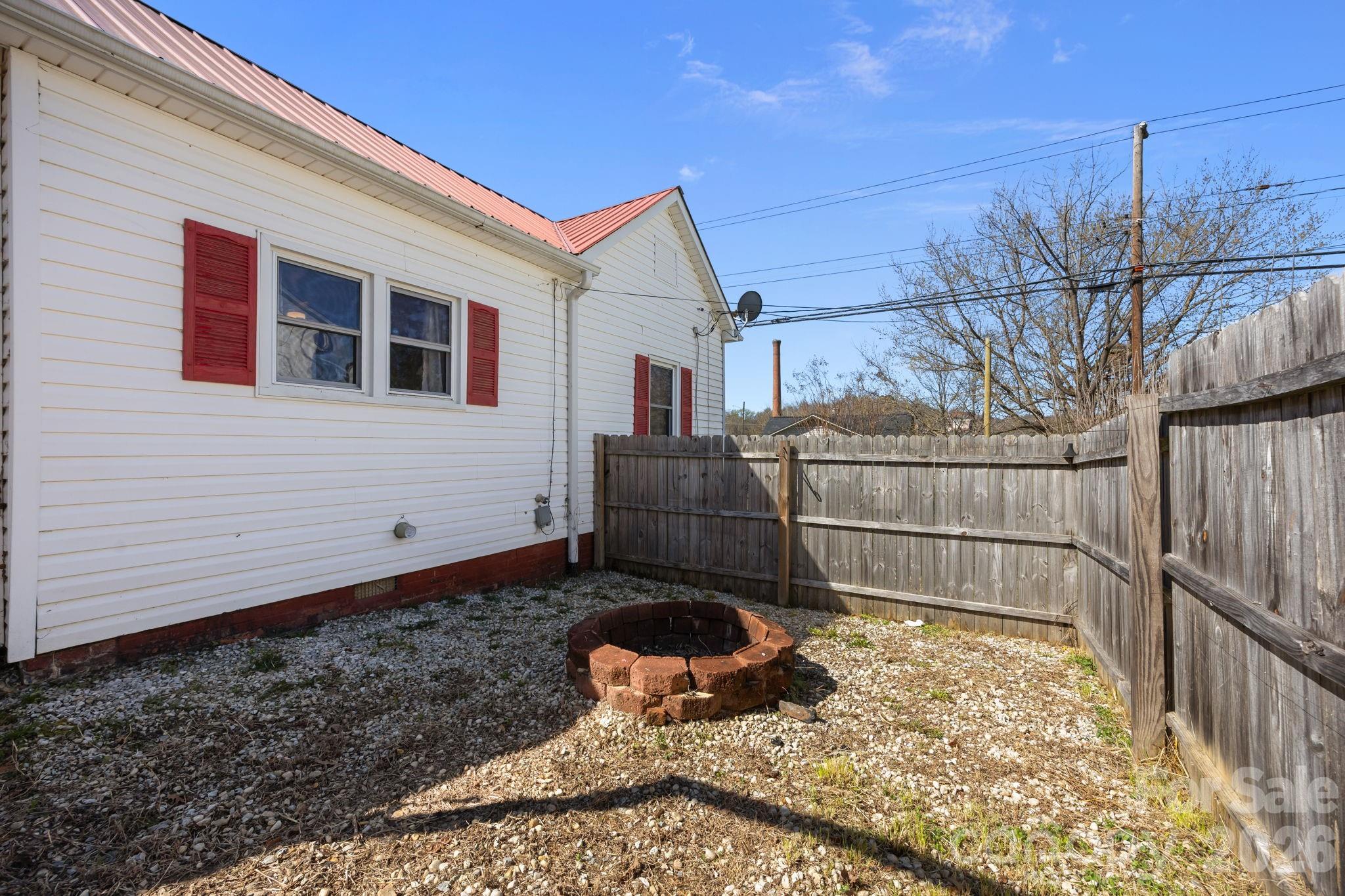 264 Church Street Marion, NC 28752 - Photo 18 of 20 a view of a backyard with wooden fence and large trees