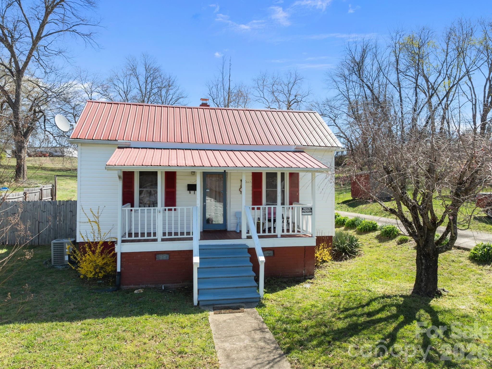 264 Church Street Marion, NC 28752 - Photo 2 of 20 a view of a house with a yard porch and sitting area