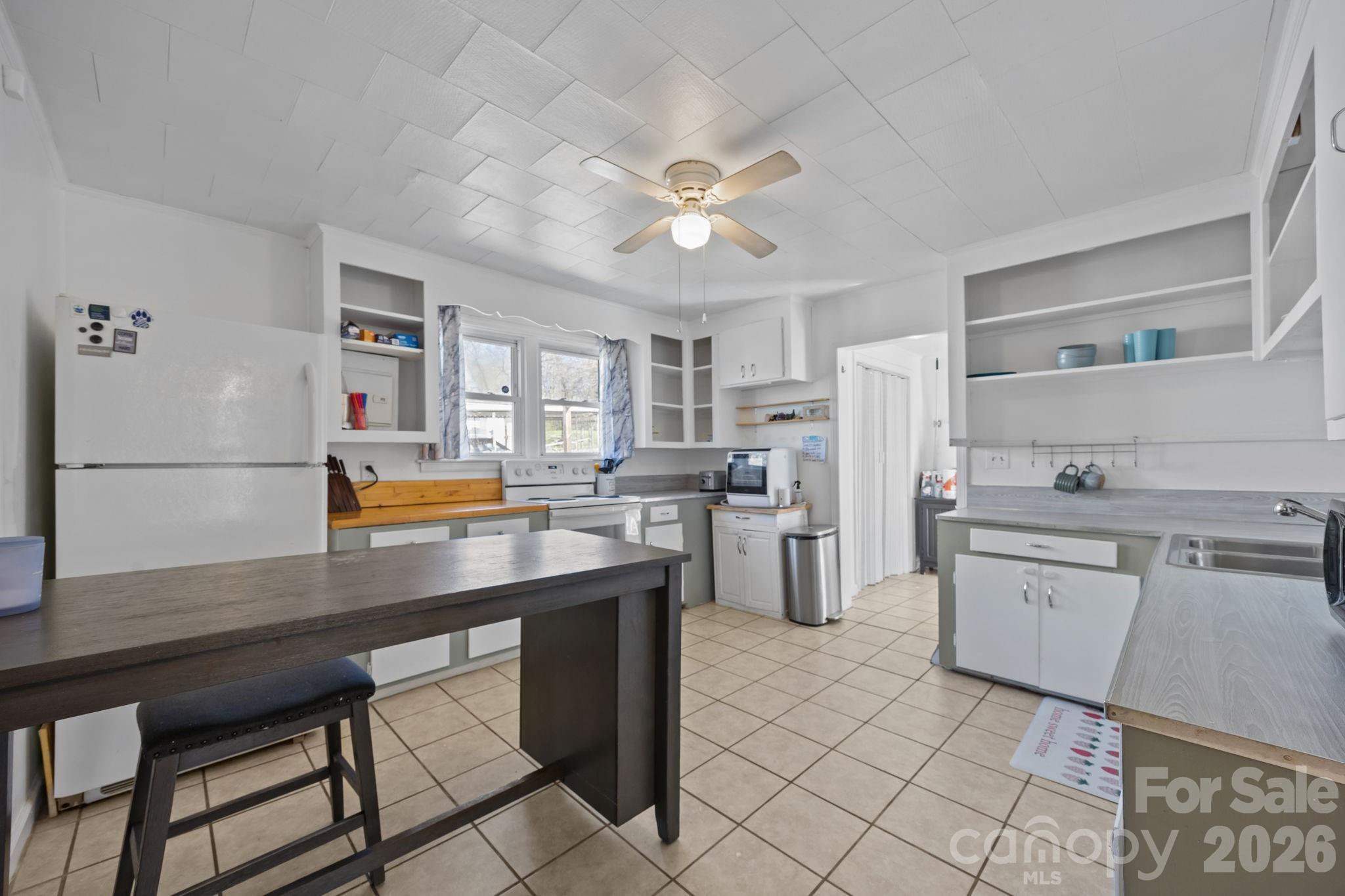 264 Church Street Marion, NC 28752 - Photo 4 of 20 a kitchen with stainless steel appliances a stove a sink dishwasher and a refrigerator