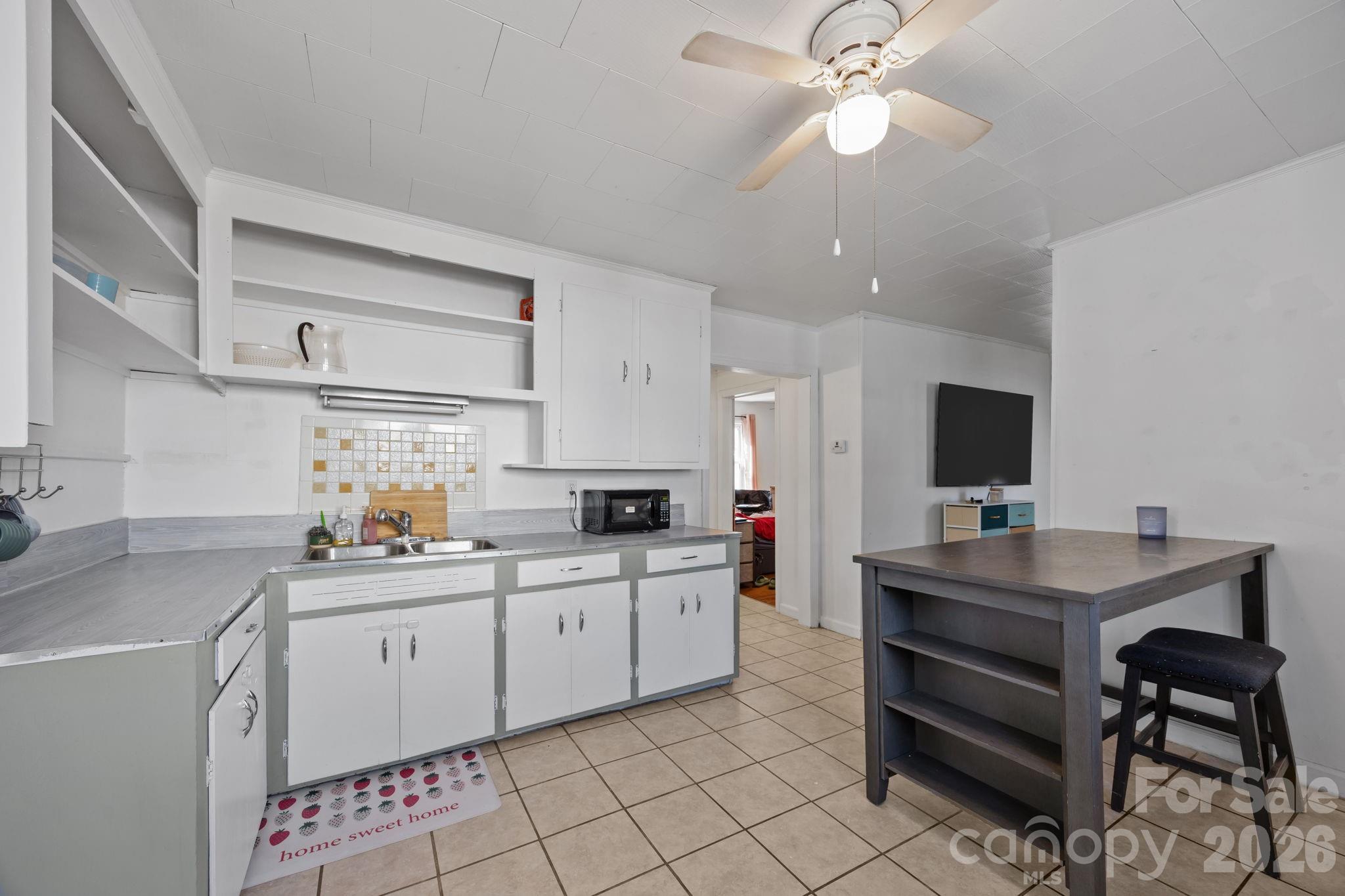 264 Church Street Marion, NC 28752 - Photo 5 of 20 a kitchen that has a sink and a stove top oven