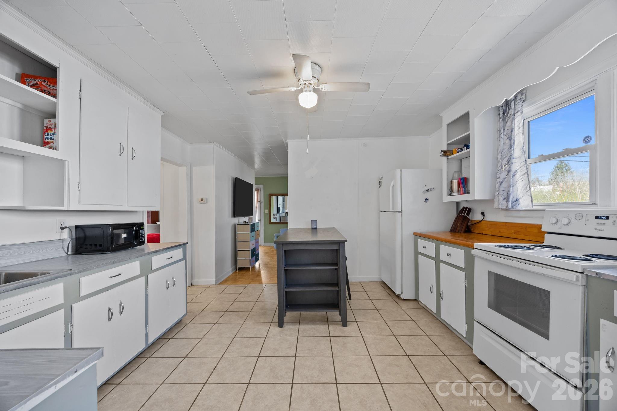 264 Church Street Marion, NC 28752 - Photo 6 of 20 a kitchen with white cabinets and white appliances