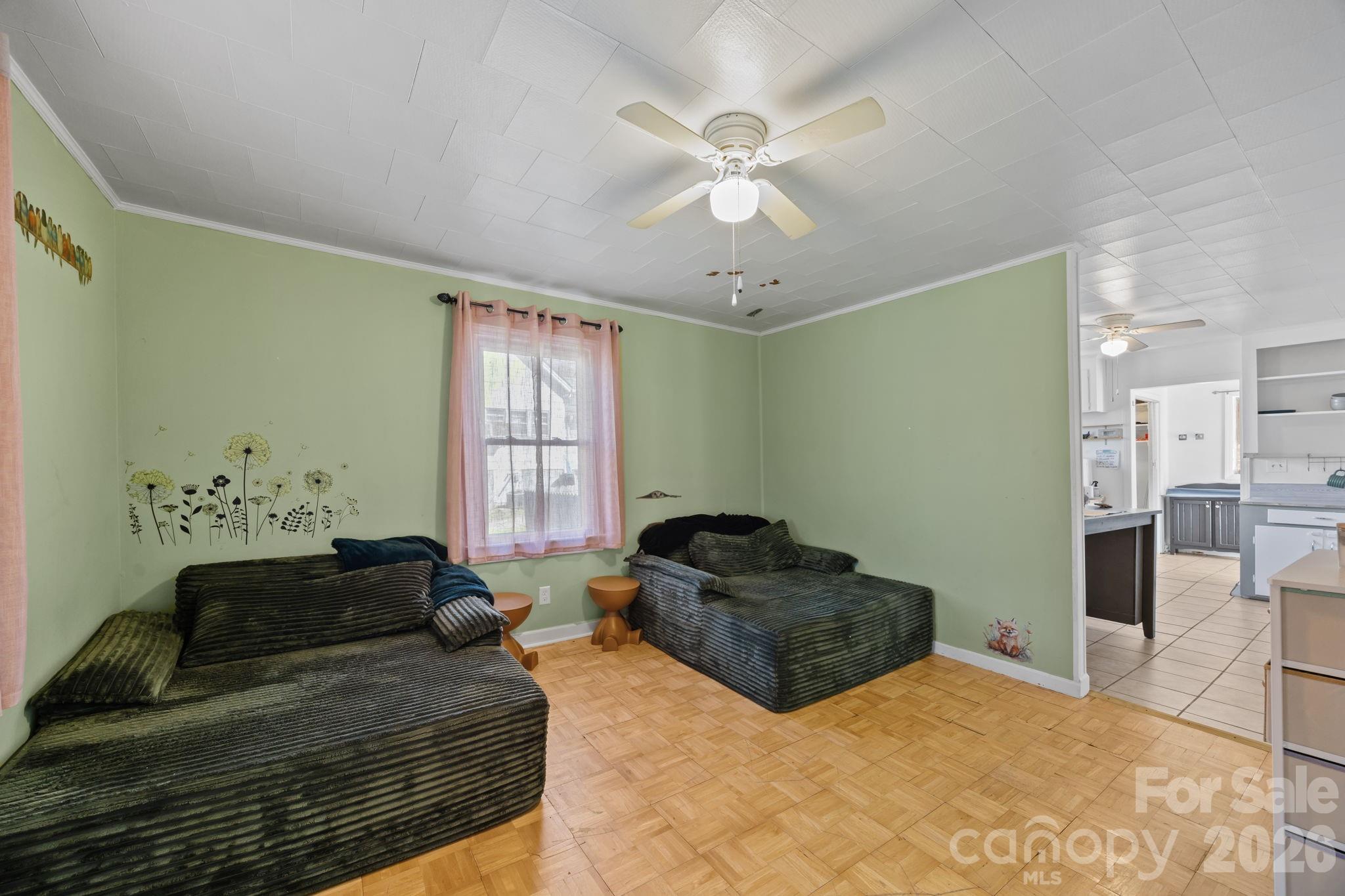264 Church Street Marion, NC 28752 - Photo 7 of 20 a spacious bedroom with a bed and a chandelier