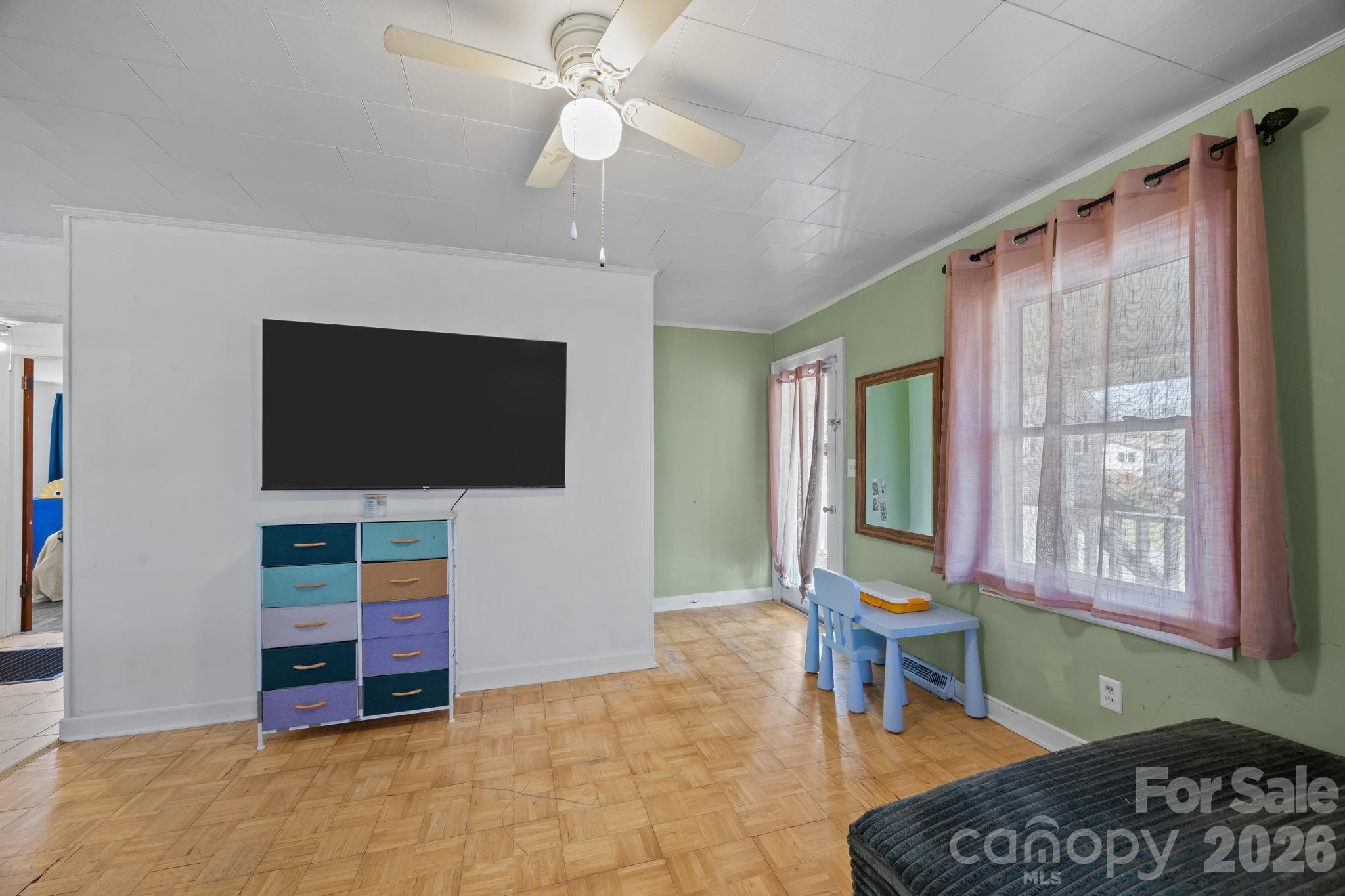 264 Church Street Marion, NC 28752 - Photo 8 of 20 a living room with furniture and a flat screen tv