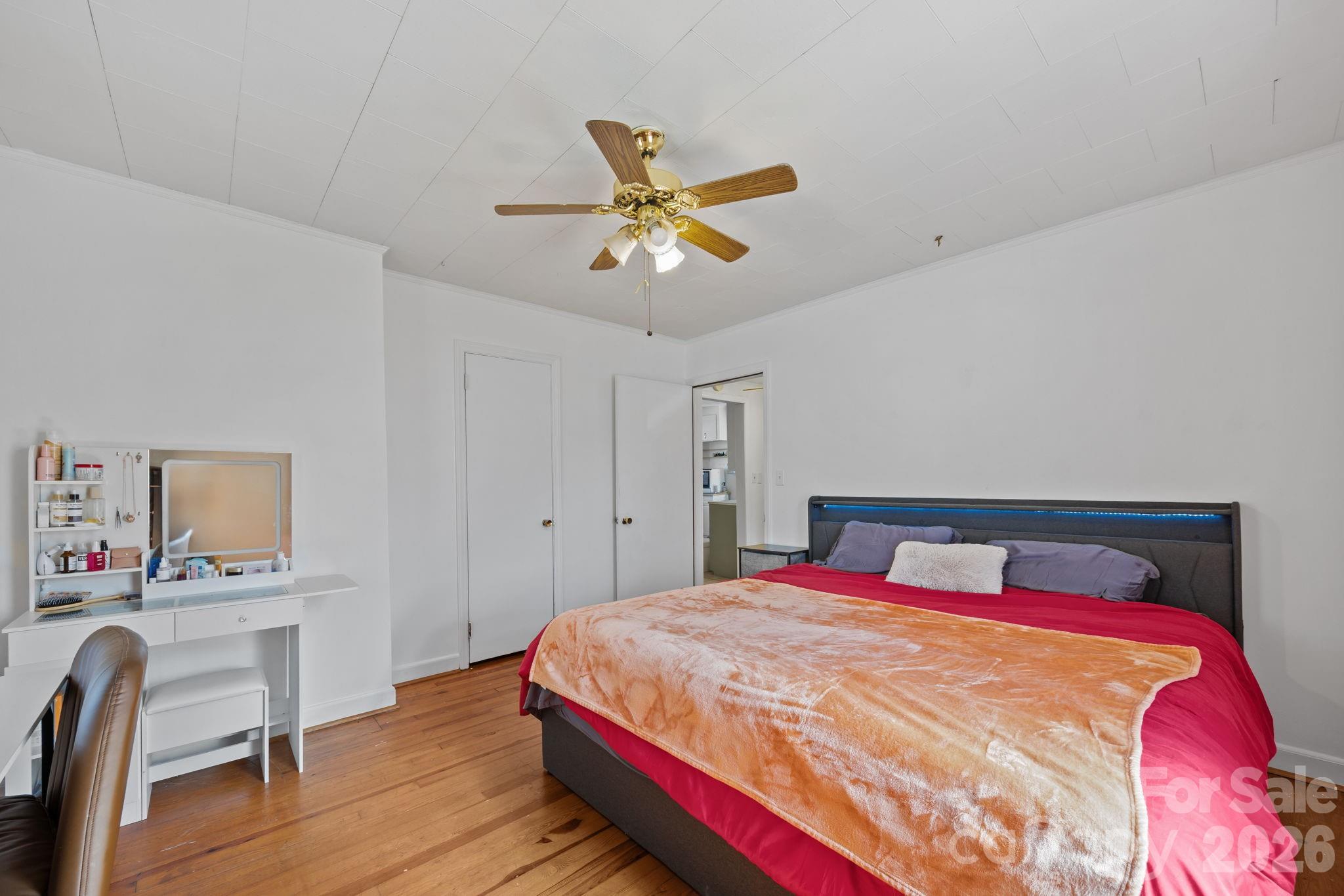 264 Church Street Marion, NC 28752 - Photo 9 of 20 a bedroom with a bed a table and chair