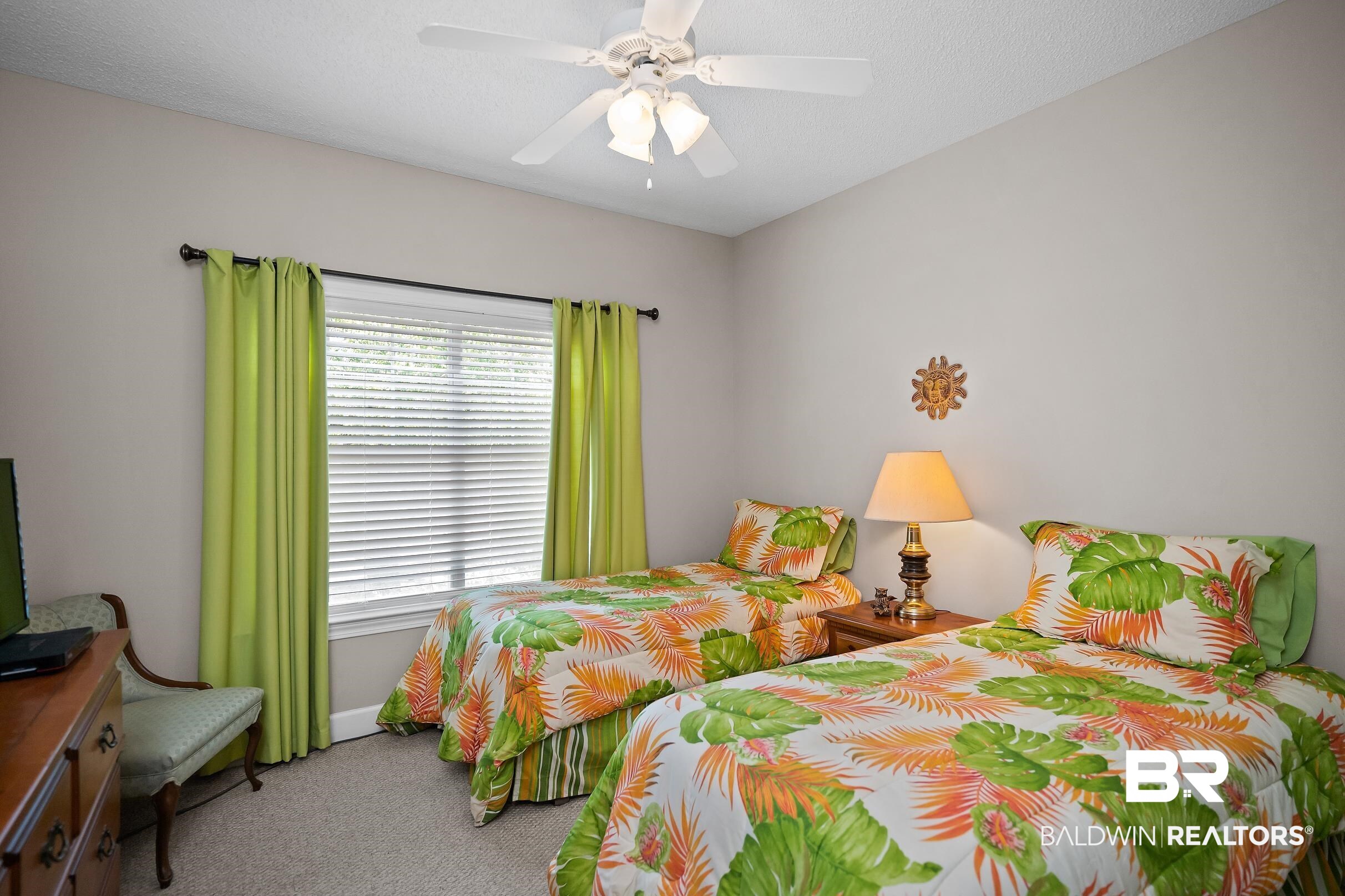 430 West Fort Morgan Road, Unit 704 Gulf Shores, AL 36542 - Photo 22 of 35 Bright room featuring a window with horizontal blinds and green curtains