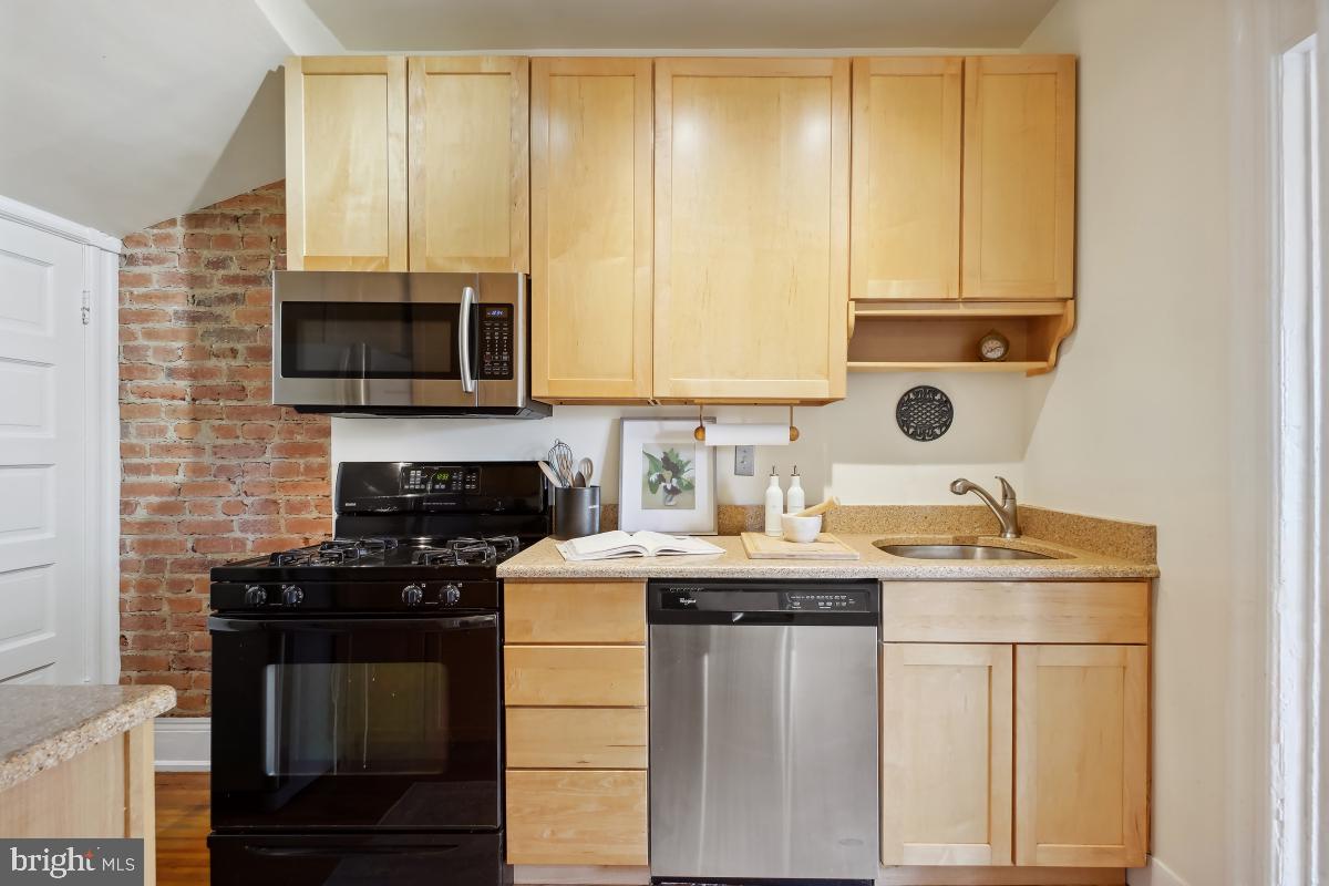 514 15th Street Southeast Washington, DC 20003 - Photo 13 of 36 a kitchen with a sink stove and microwave