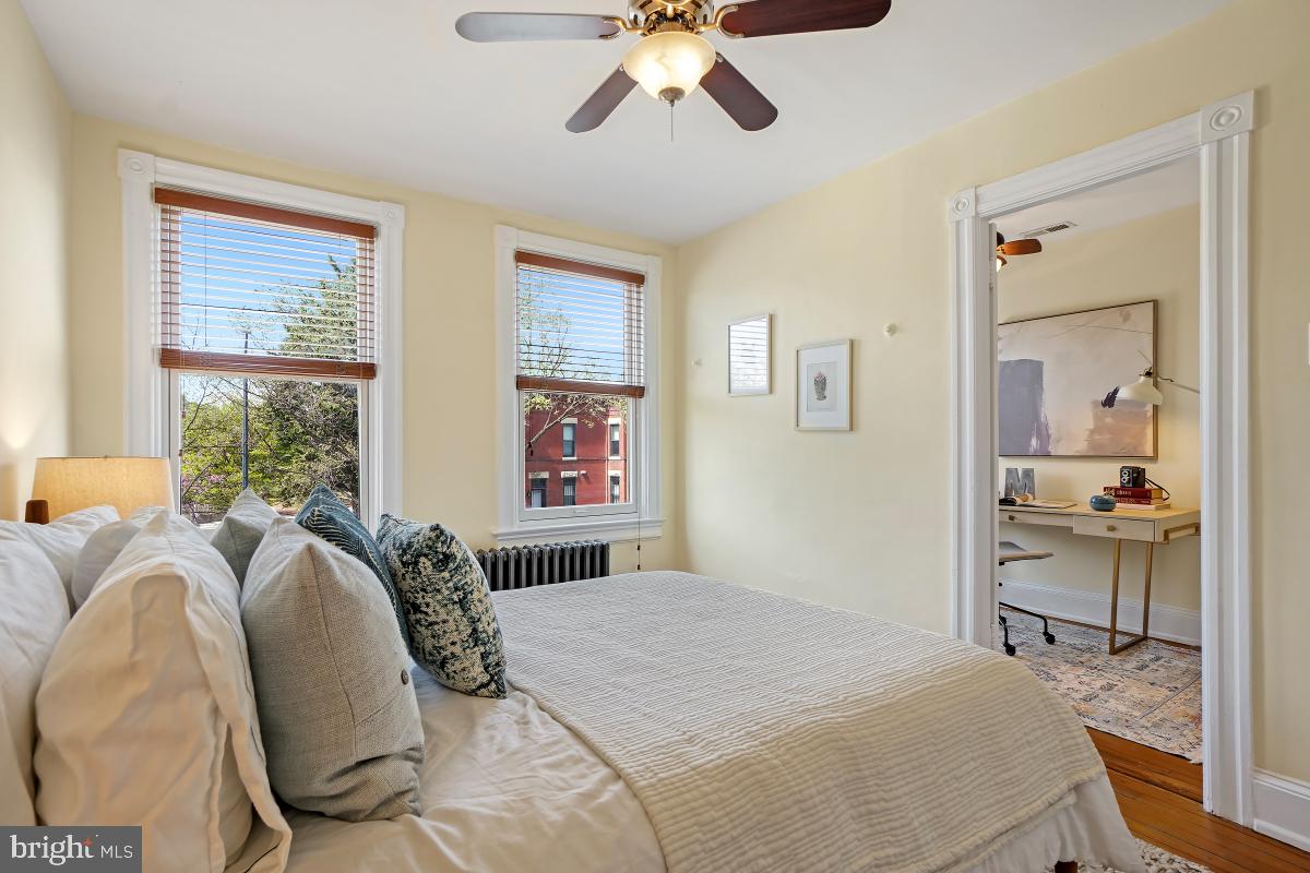 514 15th Street Southeast Washington, DC 20003 - Photo 19 of 36 a bedroom with a bed and a chandelier