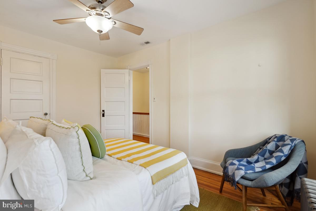 514 15th Street Southeast Washington, DC 20003 - Photo 23 of 36 a bedroom with a bed and a chandelier