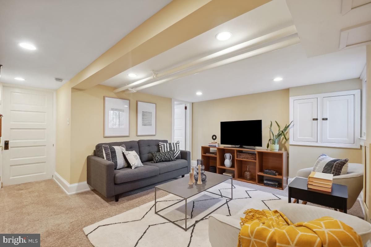514 15th Street Southeast Washington, DC 20003 - Photo 28 of 36 a living room with furniture and a flat screen tv