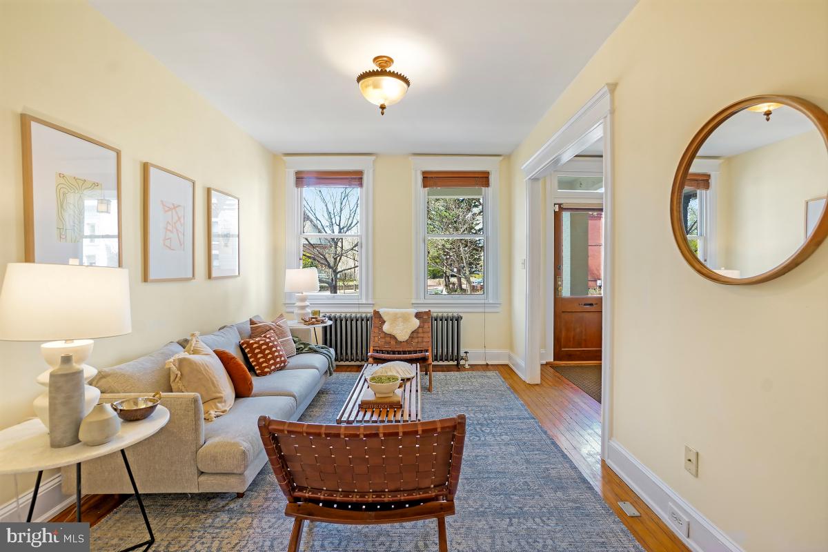 514 15th Street Southeast Washington, DC 20003 - Photo 9 of 36 a living room with furniture a chandelier and a window