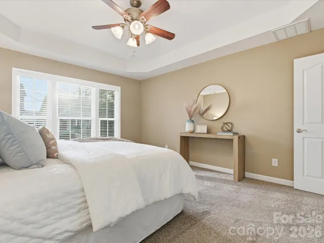 a bedroom with a bed and a large window