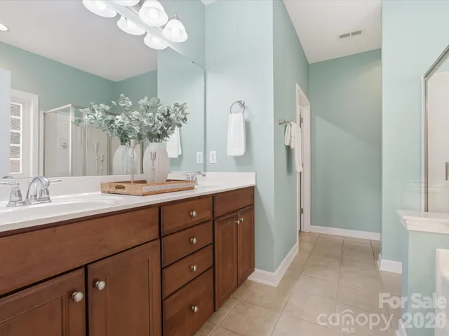 a bathroom with a double vanity sink and a mirror