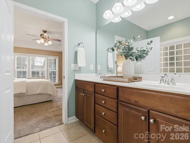 a spacious bathroom with a double vanity sink and a mirror
