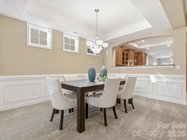 a view of a dining room with furniture and chandelier