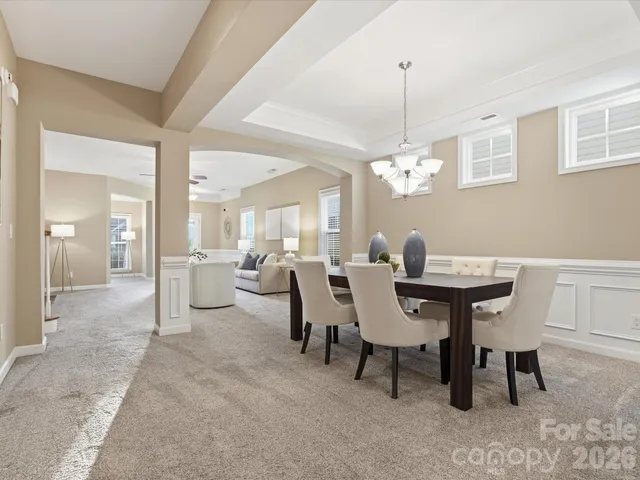 a view of a dining room with furniture and chandelier
