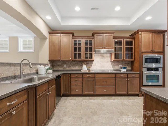 a kitchen with a sink stove and cabinets