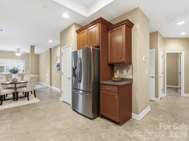 a kitchen with stainless steel appliances granite countertop a refrigerator and a stove top oven