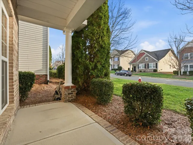 a view of a house with a yard and sitting area