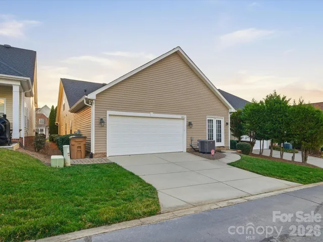 a view of a house with a yard and garage
