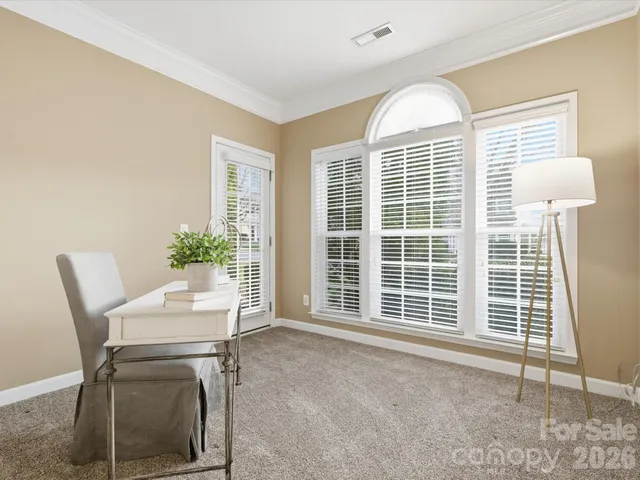 a view of a dining room with furniture and a window