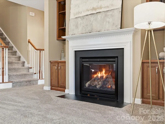 a living room with a fireplace a flat screen tv and a fireplace