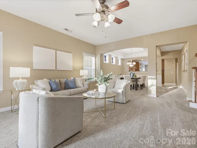 a living room with furniture and white walls