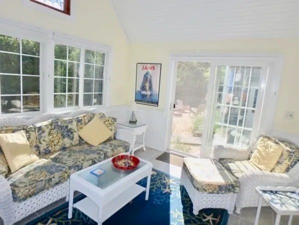a living room with furniture and floor to ceiling windows