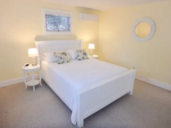 a bedroom with a bed and window