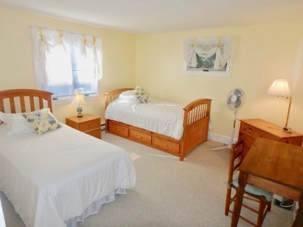 54 Schoolhouse Road Edgartown, MA 02539 - Photo 14 of 30 a bedroom with two beds and painting on the wall