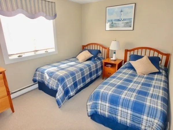a bedroom with two beds and a window