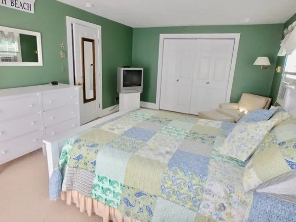 a bedroom with a bed and a mirror