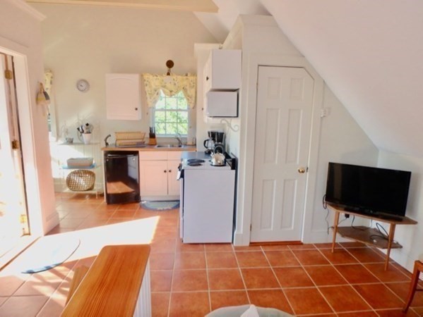 54 Schoolhouse Road Edgartown, MA 02539 - Photo 21 of 30 a room with a bed and a flat screen tv