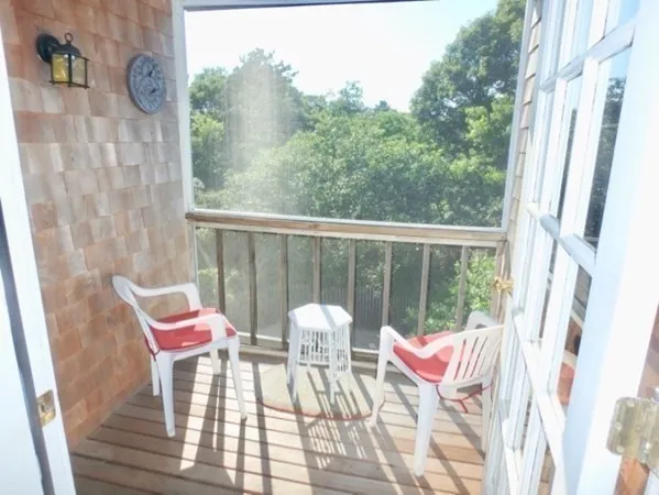 a view of a chairs and table in the balcony