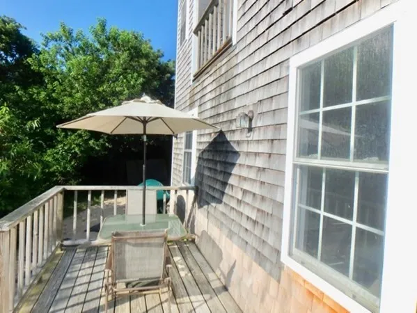 a view of house with backyard and outdoor seating