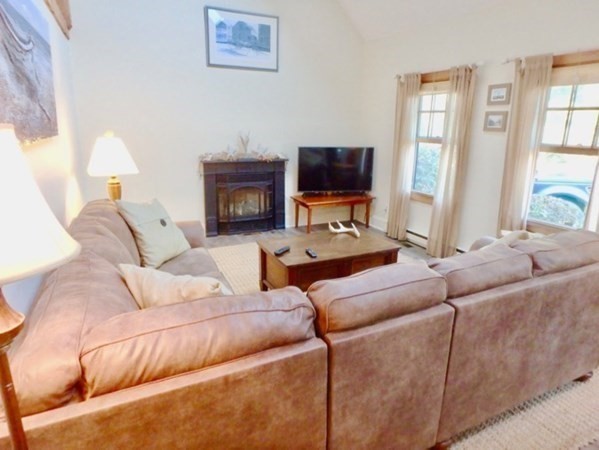 54 Schoolhouse Road Edgartown, MA 02539 - Photo 3 of 30 a living room with furniture a flat screen tv and a fireplace