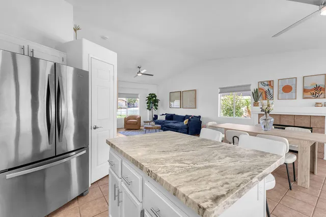 a kitchen with granite countertop a stove microwave and refrigerator