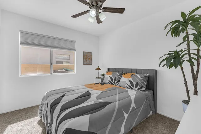 a bedroom with furniture and a flat screen tv