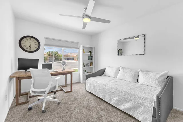 a bedroom with a bed and a view of balcony