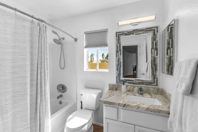 a bedroom with a bed and a night stand