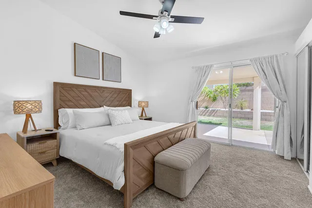 a bedroom with a bed and a night stand