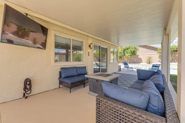a living room with furniture and a floor to ceiling window