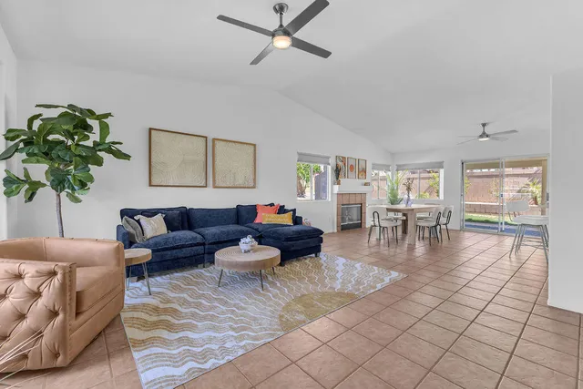 a living room with furniture and a floor to ceiling window