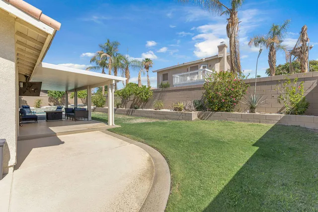 a view of a house with backyard porch and sitting area