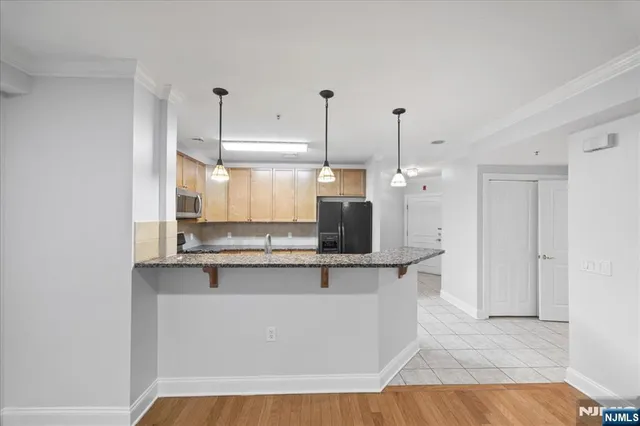 a kitchen with stainless steel appliances a refrigerator and a stove top oven