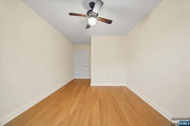 a view of empty room with ceiling fan