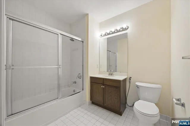 a bathroom with a toilet a sink and shower